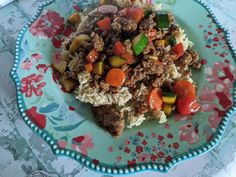 a plate with rice, meat and vegetables on it