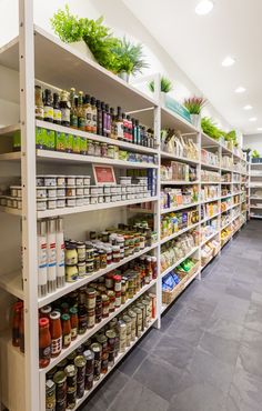 the shelves are full of spices and condiments in this large grocery store with stone flooring