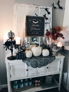 a white cabinet topped with lots of halloween decorations