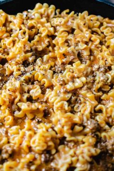 hamburger and cheese macaroni casserole in a skillet with text overlay