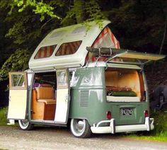 an old camper is parked on the side of the road with its doors open