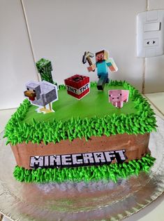 a cake made to look like a minecraft field with grass and animals on it