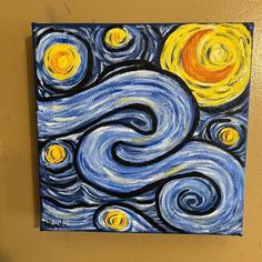 the painting is hanging on the wall with it's blue and yellow paint swirls