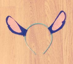 a cat ears headband is shown on a wooden surface