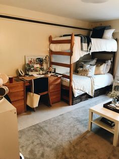 a bedroom with bunk beds and desks is shown in this image, the room has carpeted flooring