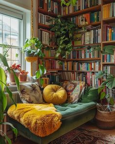 a living room filled with lots of books and plants on top of a green couch