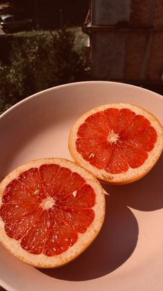 two halves of grapefruit on a white plate