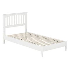 a white bed frame with wooden slats