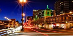 the city street is lit up with christmas lights