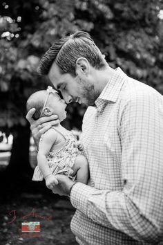 a man holding a baby in his hands