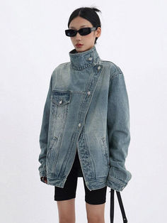 Showcasing a high collar and dark wash, this asymmetrical denim jacket is a bold reinterpretation of streetwear aesthetics. Grunge-inspired and practical with its pockets, it's a definitive piece for any urban adventurer. Picture it worn over band tees and paired with combat boots for the ultimate edgy look. Single chest pocket Twin side pockets High collar Dark wash denim Long sleeve Asymmetrical design Acubi Aesthetic, Jeans Patchwork, Denim Hoodie, Jogger Pants Casual, Loose Coats, Corset Bustier, Jacket Denim, Band T Shirts, Edgy Look