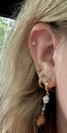 a close up of a person's ear wearing some kind of ear piercings