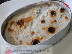 a pan filled with food sitting on top of a white plate