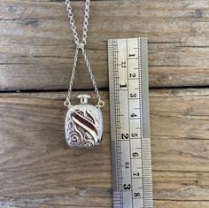 "Perfume or ashes necklace...1 1/16\" tall by 3/4\" wide at the widest spot, handmade in sterling silver 925...the chain is 20' long also in sterling silver 925 with a lobster catch...the lid is a screw top, hole size 2.8mm" Silver Locket Necklace For Formal Occasions, Rectangular Pendant Locket Jewelry For Keepsake, Formal Necklace With Rectangular Locket Pendant, Antique Sterling Silver Locket Necklace For Formal Occasions, Silver Necklace With Rectangular Pendant For Formal Occasions, Antique Sterling Silver Locket Necklace For Memorial, Antique Silver Engraved Locket Necklace For Memorial, Antique Sterling Silver Memorial Locket Necklace, Silver Hallmarked Locket Necklace For Memorial