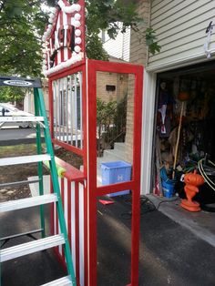 there is a red and white ladder next to a house