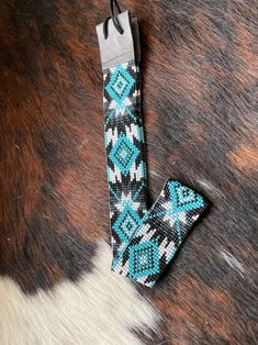 a cowhide with a blue and black design on it's side, next to a pair of scissors