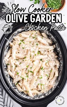 slow cooker olive garden chicken pasta in a crock pot with parsley on the side