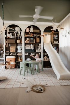 a child's playroom with toys and furniture in the room, including a slide