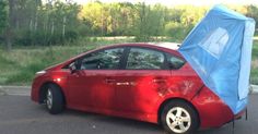 a red car with a blue cover on it