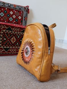 Backpack made of 100% leather, lined inside that gives it quality and durability. Perfect for hiking or using it on a daily basis as a bag replacement, or to use it at university. It has 4 pockets, 3 front pockets and a hidden back pocket to store valuable things. Made by hand and with colors made from natural dyes. Measures cm Yellow Leather Rectangular Backpack, Yellow Rectangular Leather Backpack, Handmade Leather Backpack, Backpack Purse, A Bag, Natural Dyes, Leather Backpack, Morocco, Art Collection