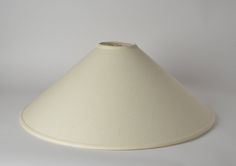 a white lamp shade sitting on top of a table