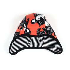 an orange hat with black and white designs on it