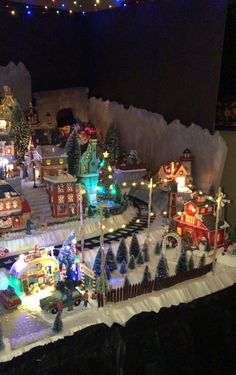 a model train set is shown with christmas lights