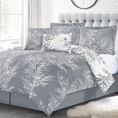 a bed in a bedroom with white and gray decor