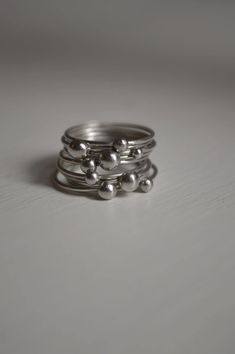 This set has 9 silver stacked rings. One of a kind. Size 6 1/2 They are already made and ready to ship. Modern Stacked Ring Jewelry, Modern Handmade Stackable Rings For Anniversary, Modern Silver Stackable Bands, Stacked Round Promise Rings, Modern Stackable Silver Bands, Modern Stacked Jewelry, Sterling Silver Stacked Jewelry For Anniversary, Stacked Sterling Silver Jewelry For Anniversary, Silver Stacked Midi Rings As A Gift