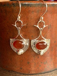 Carnelian and a pearl set in sterling silver in an art nouveau design make these earrings exquisite. A lovely romantic design that reminds me of regal gowns and forest adventures. Carnelian restores vitality and motivation, and stimulates creativity. It gives the wearer courage. Matched perfectly with pearl which is symbolic of the wisdom gained through experience. The perfect gift for Valentine's day for someone you love or admire. Elegant Carnelian Earrings, Elegant Carnelian Drop Earrings, Elegant Carnelian Jewelry For Formal Occasions, Silver Victorian Pearl Earrings For Anniversary, Victorian Silver Pearl Earrings For Anniversary, Victorian Carnelian Jewelry For Formal Occasions, Vintage Carnelian Jewelry For Weddings, Vintage Carnelian Jewelry For Wedding, Elegant Carnelian Dangle Earrings