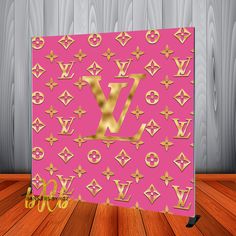 a pink and gold louis vuitton sign on a wooden floor