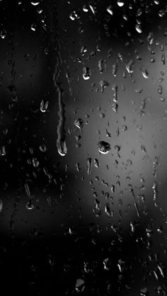 black and white photo of rain drops on window