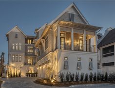 a large white house with lots of windows and balconies on the second floor