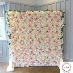 a large flower wall with pink and white flowers on it's sides in a room