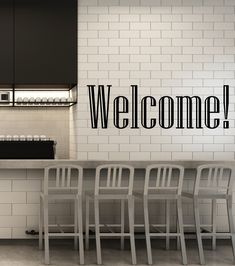 an energy = milk coffee sign is on the wall in this modern kitchen with bar stools