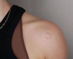 a woman with a small tattoo on her shoulder