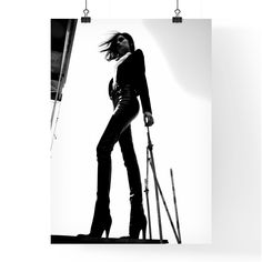 a black and white photo of a woman in high heels with skis on her feet