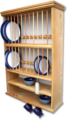 a wooden shelf with blue and white plates on it's sides, against a white background