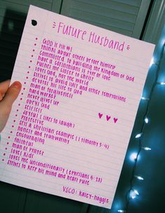 a person holding up a piece of paper with writing on it that says future husband