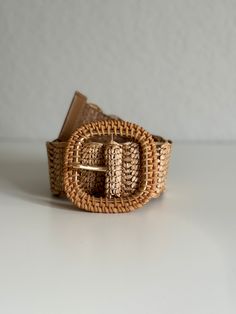 Enhance your wardrobe with our exquisite Woven Raffia Belt, featuring a stylish rattan buckle. This high-quality belt in a versatile tan color effortlessly coordinates with any outfit, making it a must-have accessory for every season. Lightweight yet durable, it provides the perfect blend of fashion and functionality. Whether you're dressing up for a special occasion or adding a chic touch to your casual attire, this belt is designed to complement your style beautifully. Embrace the natural eleg Beige Woven Belt For Vacation, Beige Woven Belts For Spring, Chic Adjustable Brown Belt, Elegant Belt With Buckle Closure For Spring, Spring Beige Woven Belt, Elegant Spring Belt With Buckle Closure, Adjustable Beige Belt For Spring, Adjustable Spring Belt With Buckle, Spring Adjustable Beige Belt