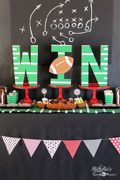 a football themed dessert table with the word nn spelled out in green and red