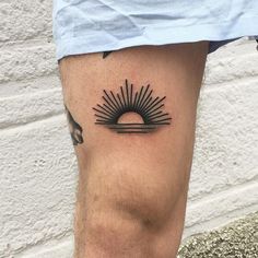 a man's leg with a tattoo on it and the sun in the middle