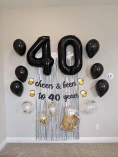 balloons and streamers are hanging on the wall in front of an fortyth birthday sign