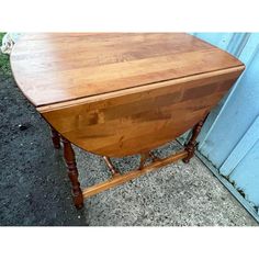 an old wooden table sitting in front of a blue door