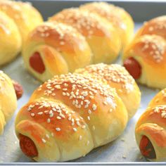 hot dogs wrapped in bread with sesame seeds