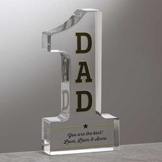 a glass trophy with the word dad on it