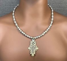 "This Silver Ethiopian cross pendant necklace is a perfect unisex jewelry gift for both men and women! It measures 20 to 24 inches and is made from recycled silver coin beads from Ethiopia along with a silver Ethiopian Coptic cross pendant.  This style of necklace has been worn By Ethiopian Christians for hundreds of years and are considered treasured heirlooms. Each bead along with each pendant is handmade by an African craftsman. This necklace has a very organic handmade feel and makes a wonde Silver Cross Beaded Necklace For Spiritual Style, Silver Spiritual Cross Beaded Necklace, Cross Necklace With Silver Beads For Gift, Spiritual Silver Cross Beaded Necklace, Necklace For Him, Ethiopian Cross, Cross Pendent, Coptic Cross, Ethiopian Jewelry