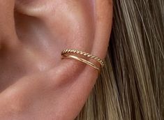 The LANI ear cuff adds a special touch to your ear curation. No piercing needed. It sits comfortably in the same area as a conch piercing. Sold as a single ear cuff to mix and match. - 14K recycled solid gold - elegant twisted and smooth design - can be slightly bent to open and close for comfort and security - approx. 12mm in diameter Order This item is made to order just for you - please allow 1-5 days for production Customs This item ships from the USA. International customers might be charge Conch Piercing Styling, Fake Double Piercing Earrings, Percing Conch, Conch Earring Jewelry, Conch Hoop Piercing, Ear Curation, Conch Jewelry, Ear Party, Conch Earring