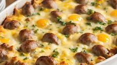 a casserole dish with meatballs and cheese