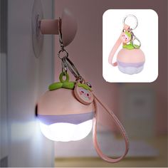 a light up keychain hanging from the side of a door with a cat on it